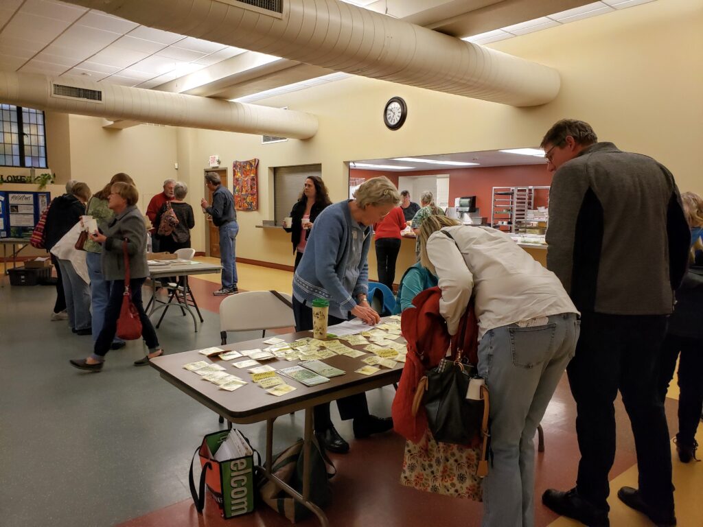 volunteers helping welcome visitors to the monthly speaker meeting